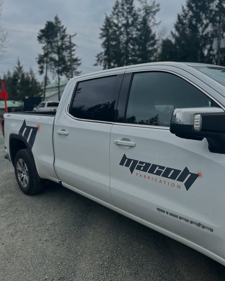 Close-up of Macon Fabrication logo on a white service truck